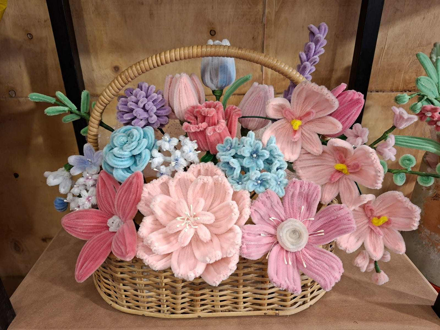 Luxury pastel flower basket with pink, blue and lavender floral arrangement.