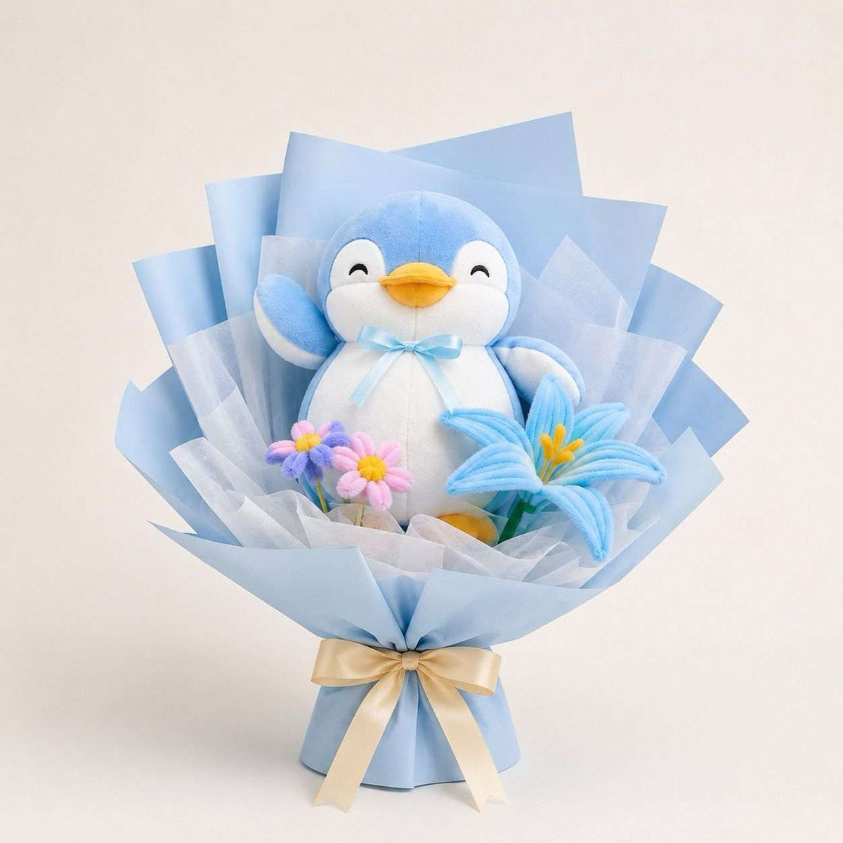 Blue penguin floral bouquet with plushie and pastel flowers.