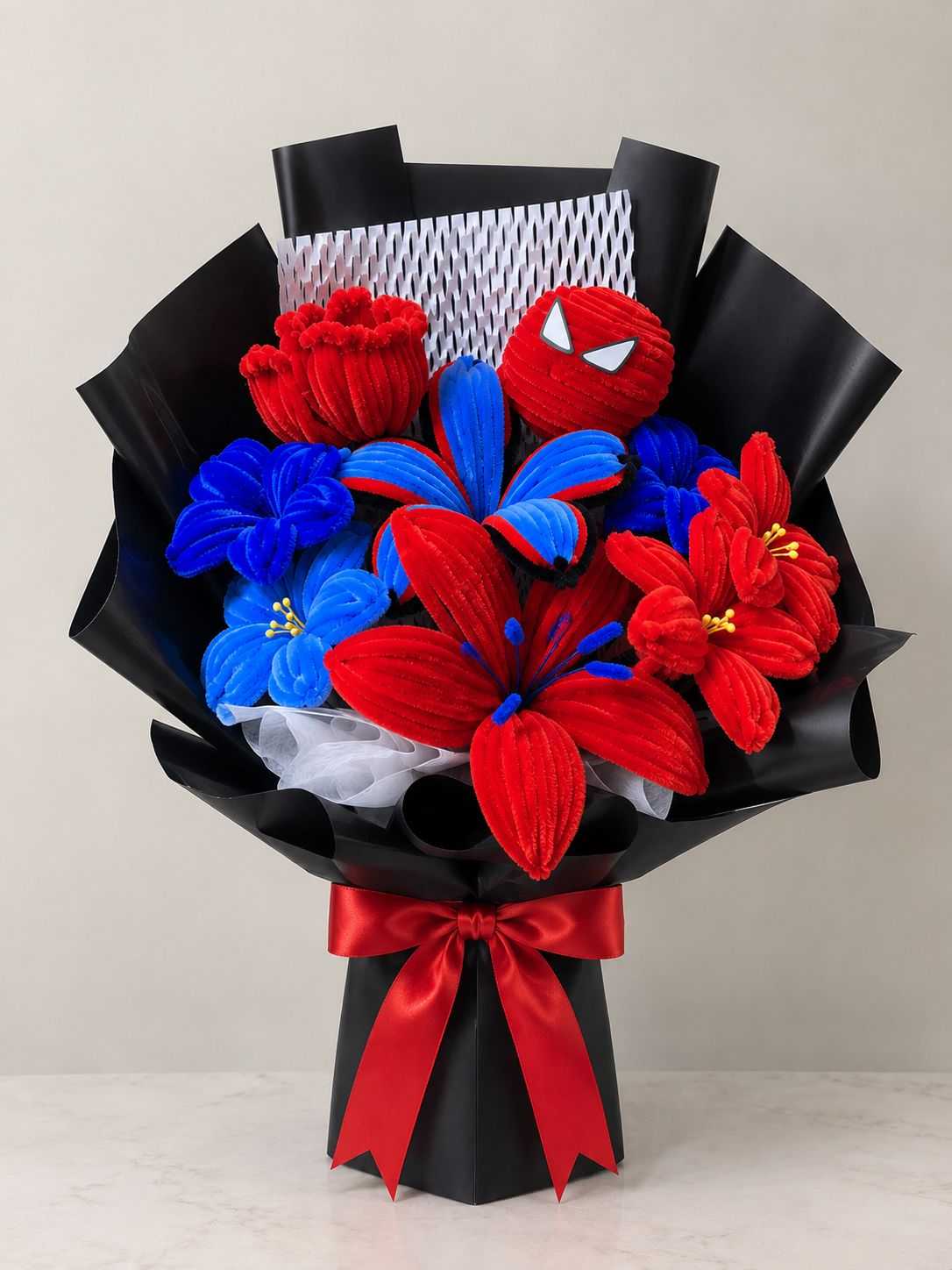 Spiderman bouquet with red and blue plush flowers and superhero-themed design.