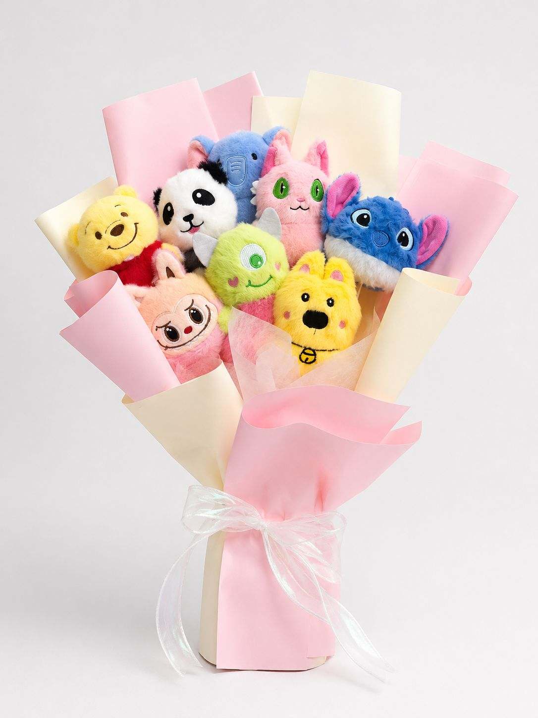 Character plushie gift bouquet with cute stuffed toys in pink wrapping.