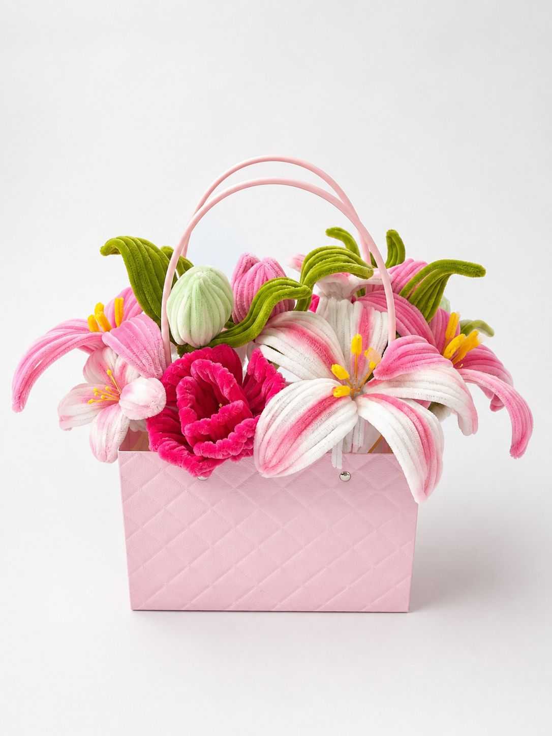 Pink lily flower gift basket with pink and white floral arrangement.